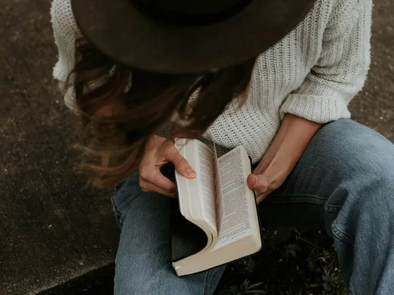 People buying more Bibles is a wonderful thing—if they will read and study what’s in them. A woman opening a Bible.
