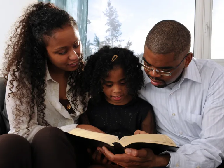A family reading a Bible together.