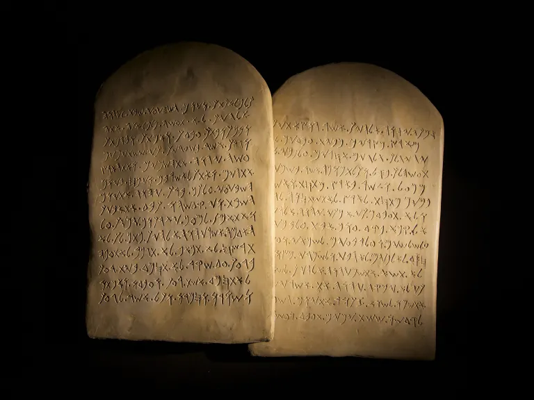 two tablets of stone with ancient writing on them
