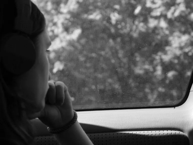 a person looking out the window of a car