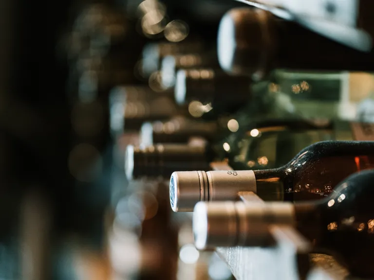 The problem of alcoholism thrives in an atmosphere where knowledge and awareness are lacking. a row of wine bottles on their sides
