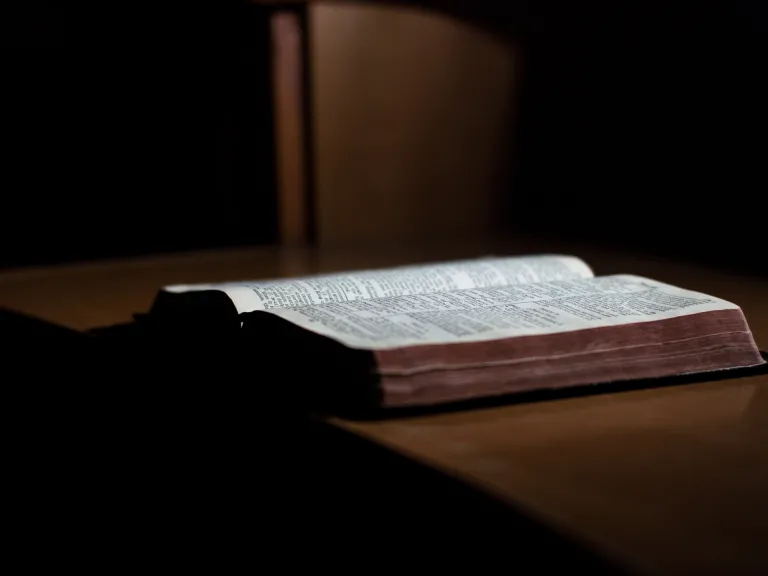 An open Bible laying on a table.