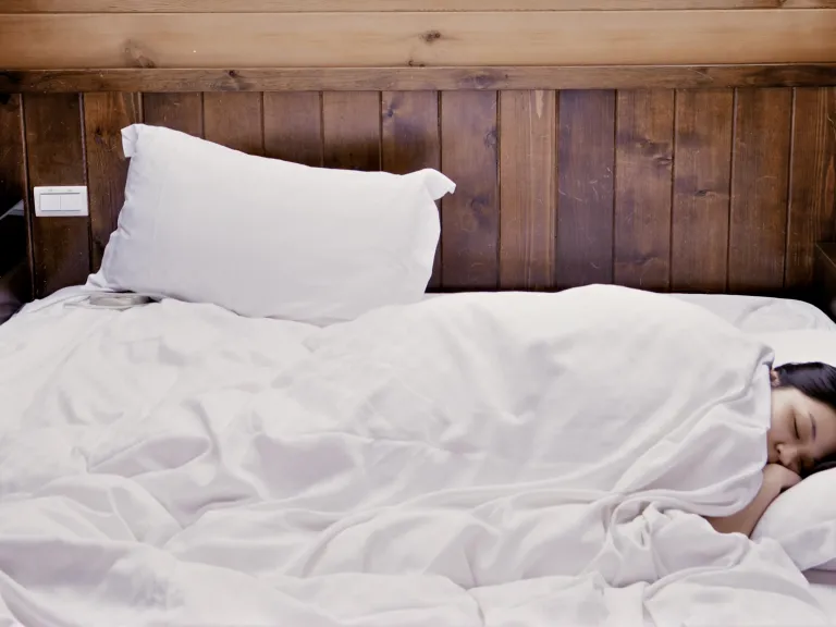 A woman sleeping in a bed.