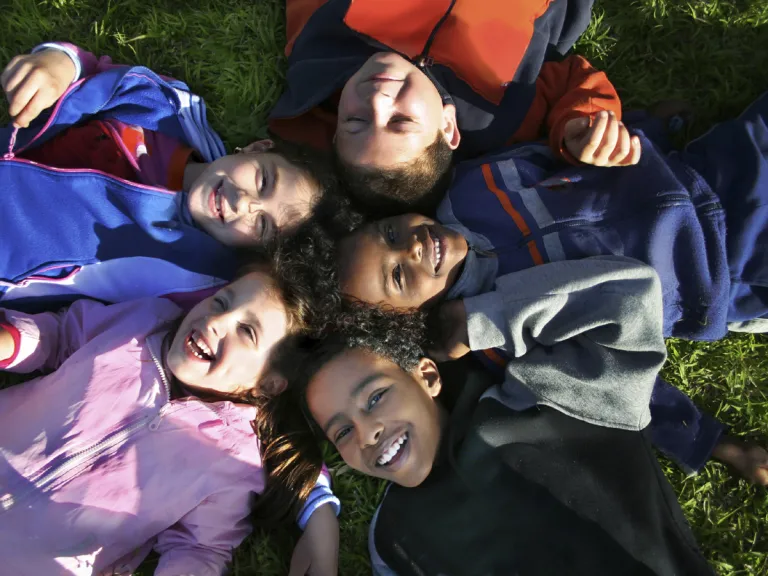 This period is the time for all other people to learn the truth of God and enjoy the same opportunity for salvation given to those who lived during the Millennium. Young kids laying on the ground and looking up.