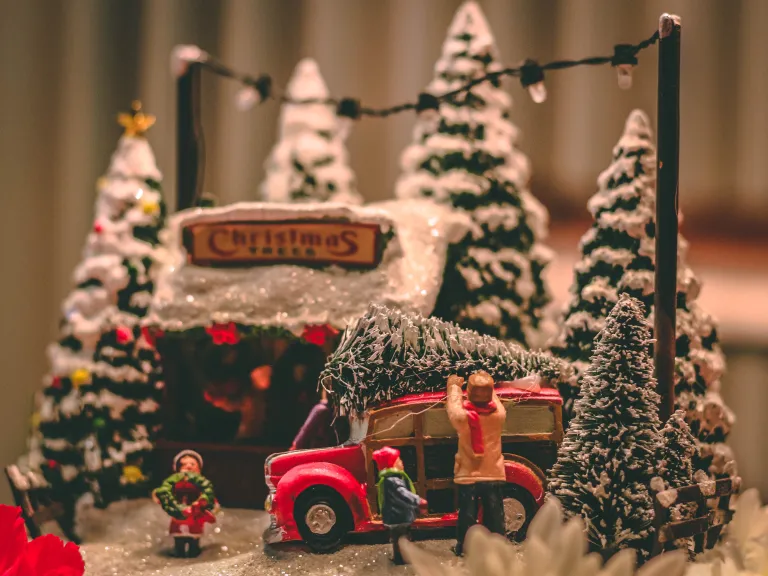 A miniature Christmas scene of gathering a Christmas tree.