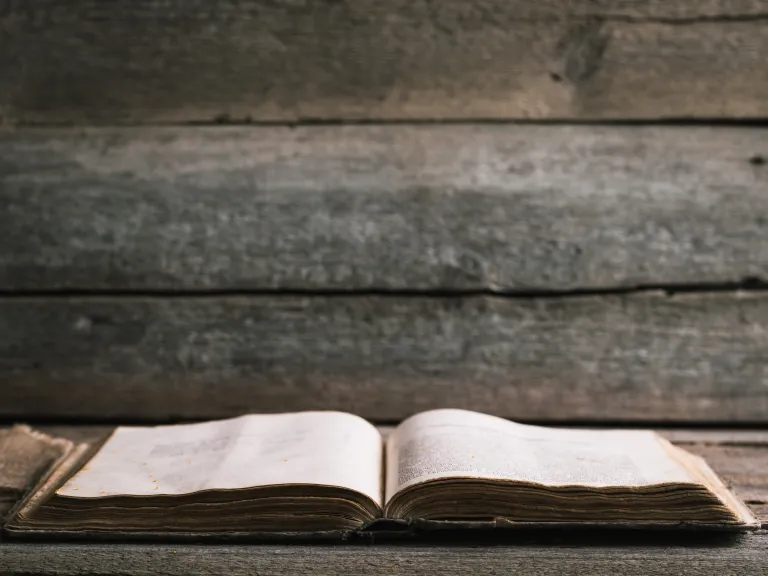 The Bible simply says that God “took him.” It does not specify where he was taken. An open Bible laying on a table.