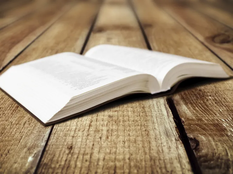 An open Bible laying on a table.