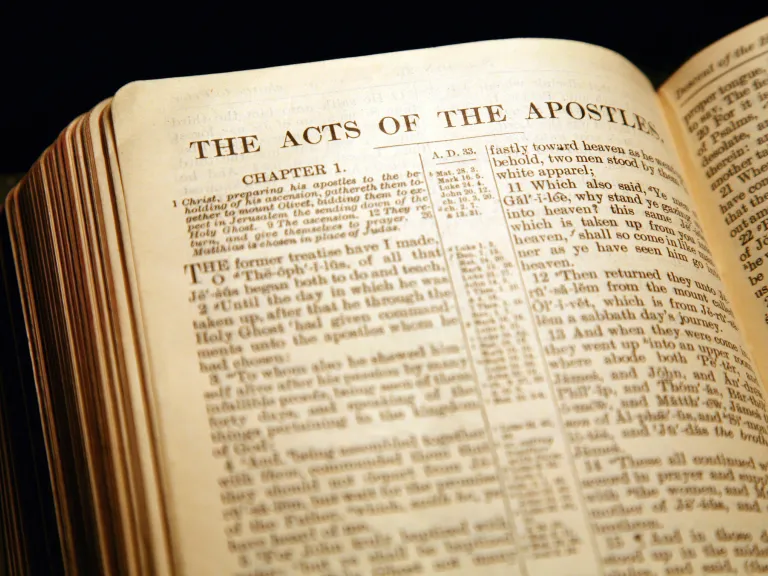 A Bible opened to the book of Acts.