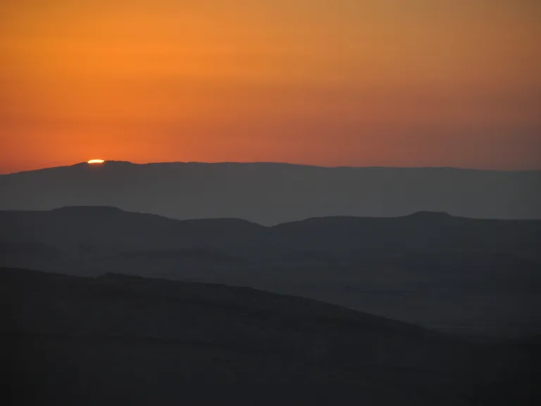 Sunset over desert hills.