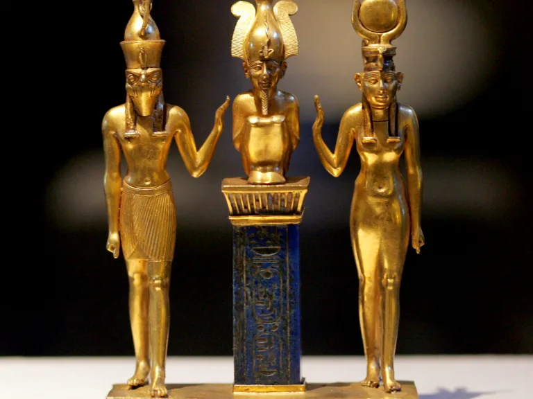 Gold figurines of Egyptian gods Osiris, Horus and Isis