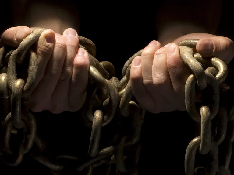 Sin is like a trap; lawlessness is a snare. It may look harmless until the consequences begin to appear. Then the sinner is trapped, ensnared by his own foolishness. Hands hold heavy chains.