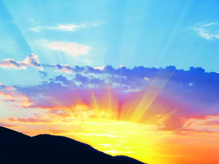 Because God wants us to be like Him, He gave us the ability to choose what we do. Without making right choices, we can’t build righteous character, the same character He has. Sun rays shining over hills.