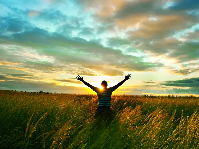 The great Creator God has designed human sexuality to be a wonderful blessing. God revealed His intent and purpose for sex when human civilization began. A person raising their hands to the sky.