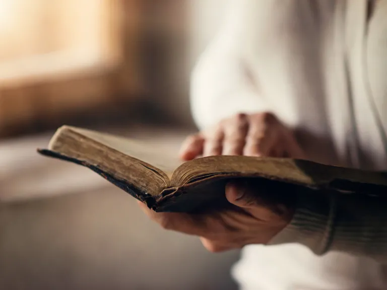 A person holding a Bible.