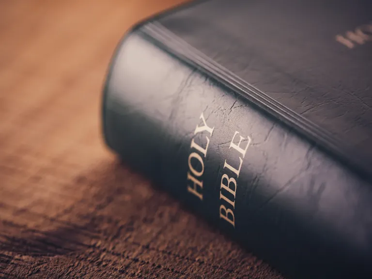 Paul’s epistles record no attempt on his part to explain the Trinity or Holy Spirit as a divine person equal with God the Father and Jesus Christ. A Bible laying on a table.