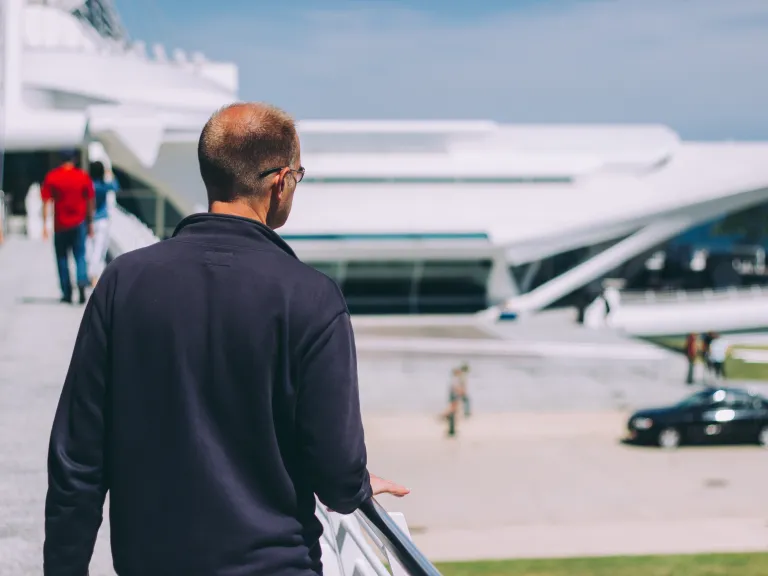 A man walking on a ramp to a building.