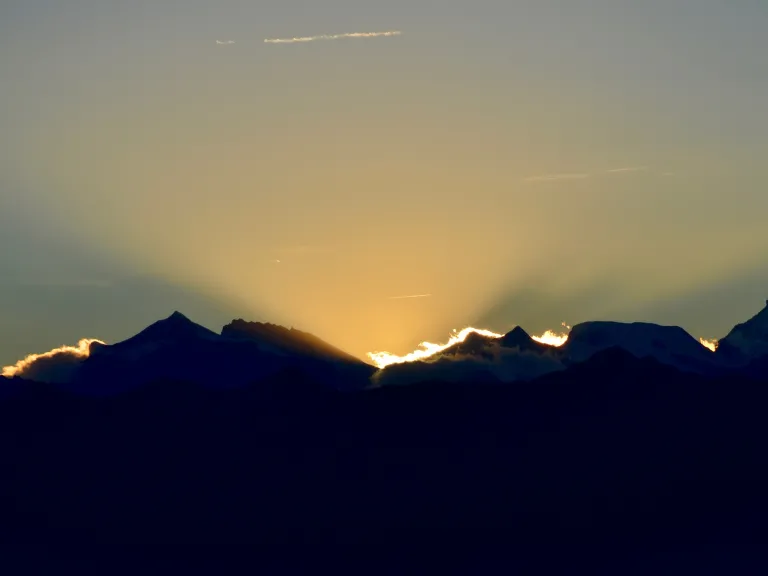 God has a plan to establish a perfect, corruption-free government that will finally help enforce peace throughout the world! A sunset over a mountain range.