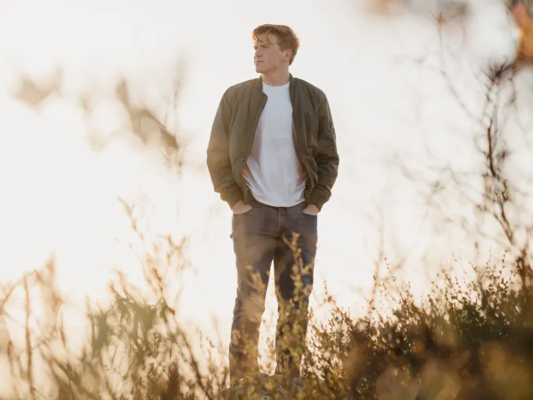 Blaspheming the Holy Spirit is a mindset that is firmly set against God and unwilling to acknowledge Him even when one knows that they should. A man walking in a field.