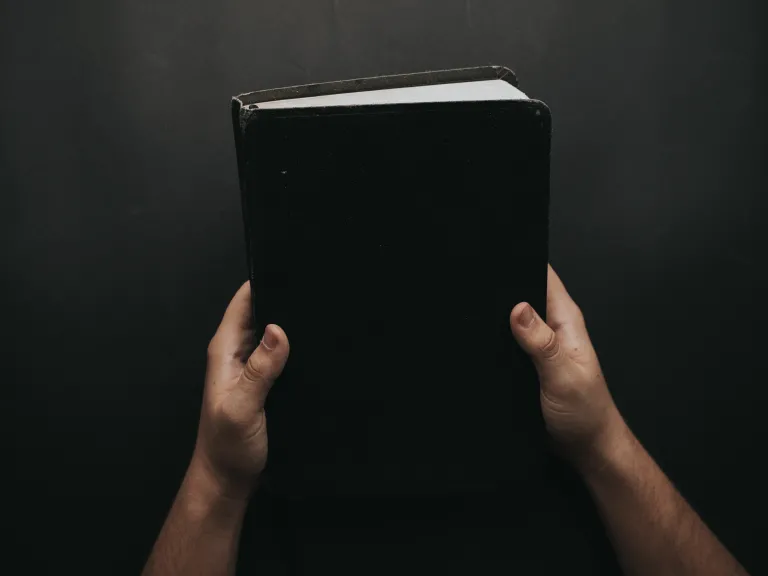 God’s clear warnings against idolatry are found in numerous biblical passages. A person holding a Bible.
