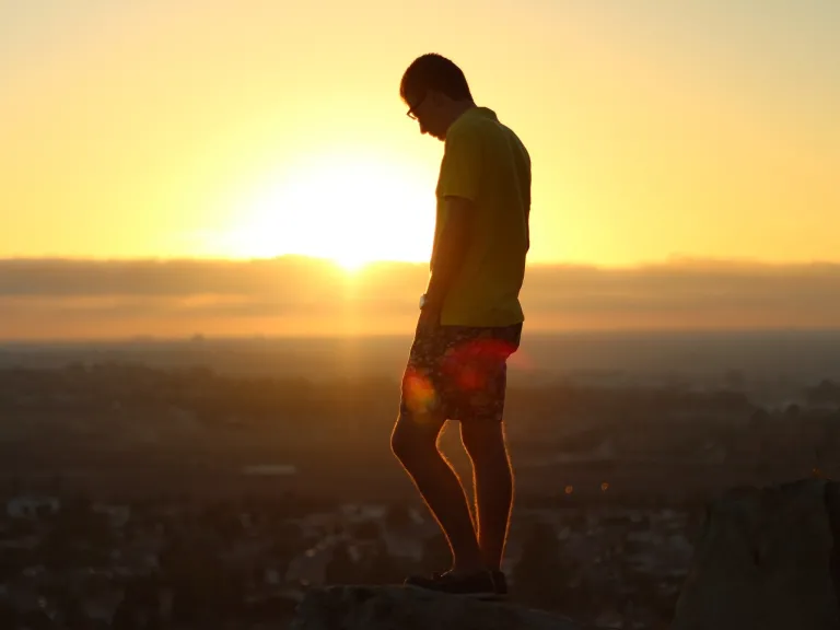 Being a friend of God, being in the good graces of God, opens the door for God to shower us with grace, with forgiveness, with restoration, with redemption, with reconciliation. A young man standing on a hill overlooking a village.