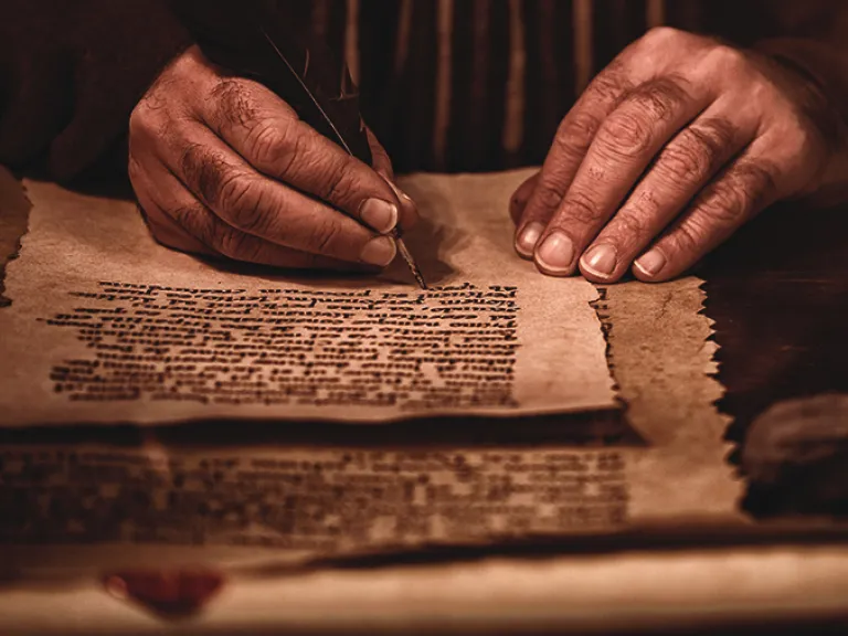 In Paul’s repeated greeting we see that the source of true grace and peace is both God the Father and God the Son, “the Lord Jesus Christ.” Both are the source of divine grace and peace. A photo illustration of man writing in a scroll.