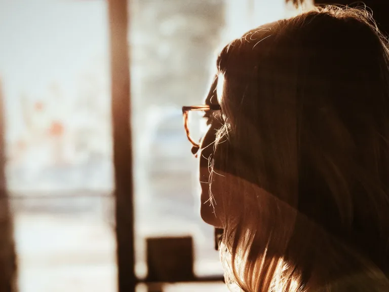 A woman looking out a window.