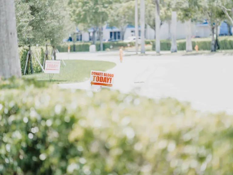 Donating blood is a special way of showing love to someone else—and possibly saving their life. Photo of a sign, pointing to a donation center, saying "Donate Blood Today."