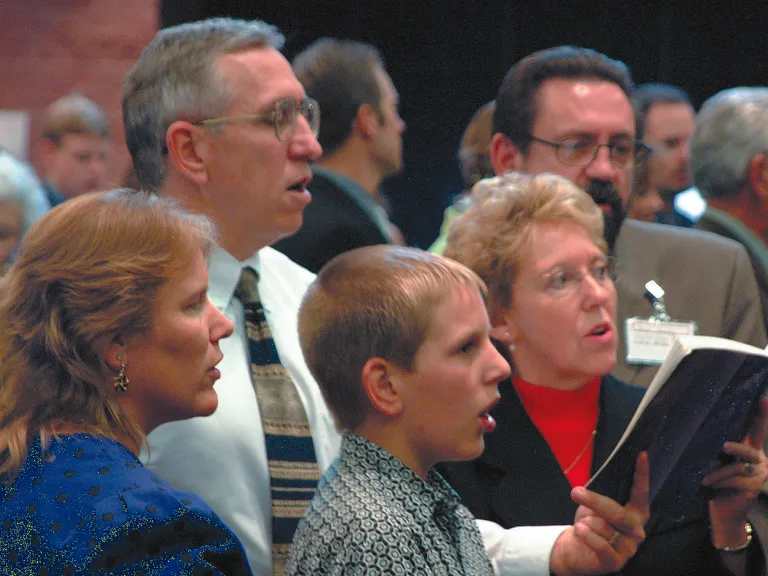 To fulfill their mission and maintain the closeness and unity that Christ expects of them, the members of His Church regularly assemble together as commanded in the Scriptures. People singing during church service.