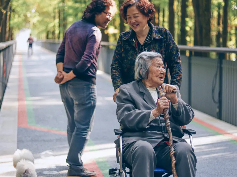 Service doesn’t need to be grandiose or flashy. Scripture often says small things result in great things! a woman pushing an older woman in a wheelchair while another woman watches