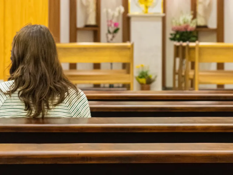 A woman sitting in a church.