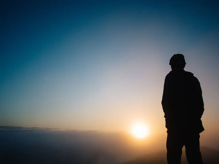 With the tremendous power of God’s Holy Spirit working in us, we have the perfect assurance of help today and a wonderful and exciting future in God’s coming Kingdom. A person looking at a sunset.