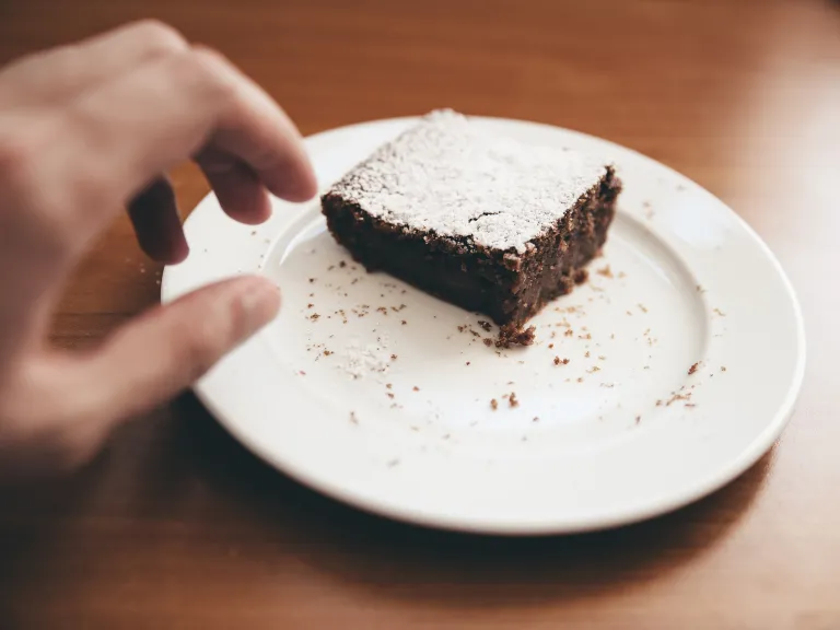 At the first hint of being tempted, immediately cry out to God! a hand reaching for a brownie on a plate