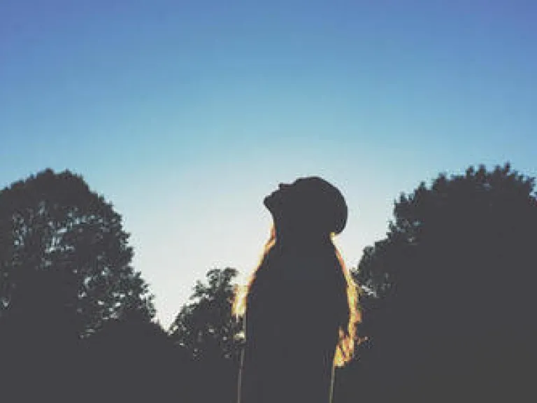 A woman look up into the sky.