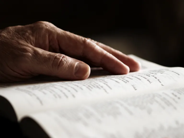 Most Christians find little meaning in God's Holy Days, but could they hold an important message for you and your future? An older man's hand on an open Bible.