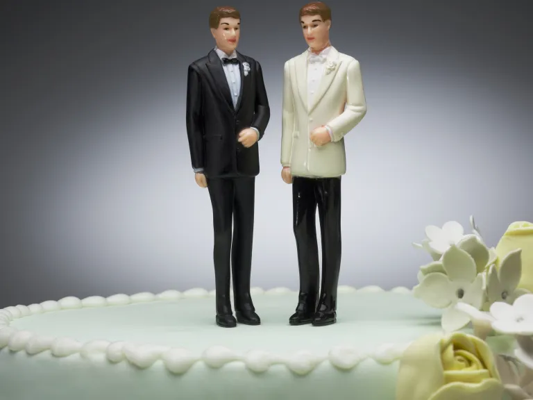 What does the Bible say about homosexuality? Two men figurines on wedding cake.