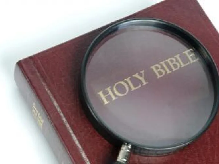 What Does the Bible Say About the "Immortal Soul"? Magnifying glass over the words Holy Bible.
