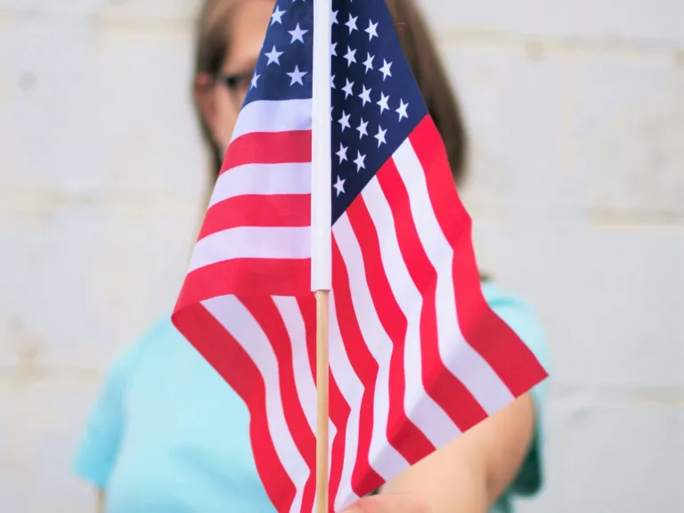 The world benefits from American ingenuity. But, American stability, which has benefitted the world, is now in question. A girl holding an America Flag