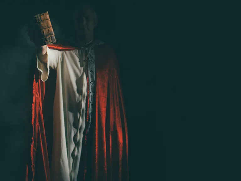 Many study the Bible wondering when the Antichrist will come in the future, but it might surprise most professing Christians to know the spirit of antichrist is already here. Image of antichrist-like figure holding a Bible.