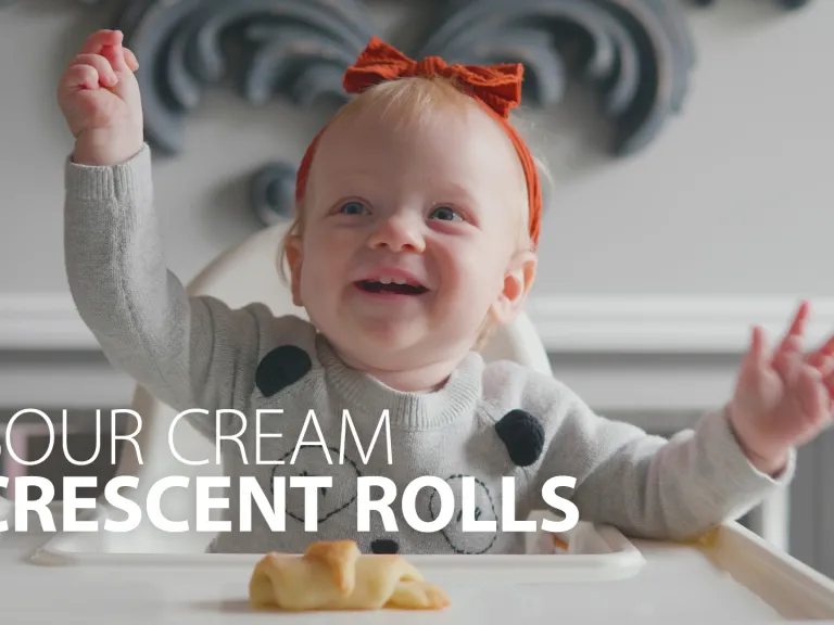 This is a photo of a baby holding the crescent roll.