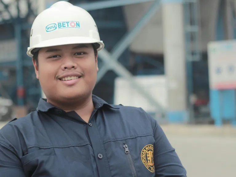 There are several important principles to keep in mind as you enter your career. a man wearing a hard hat standing in front of a construction site