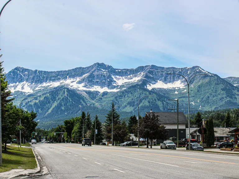 a road in a town with mountains in the background