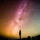 A person looking up at the millions of stars filling the night sky.