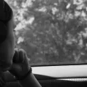 a woman looking out a car window