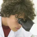 a man looking through a microscope