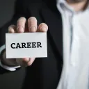 a man holding a business card that says "career"