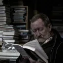 an old man reading a book