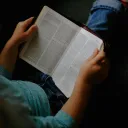an open Bible in a woman's hands