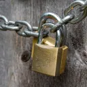 Locks on a chain in front of wooden door