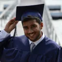a man wearing a graduation cap and gown