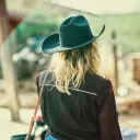 a woman wearing a cowgirl hat